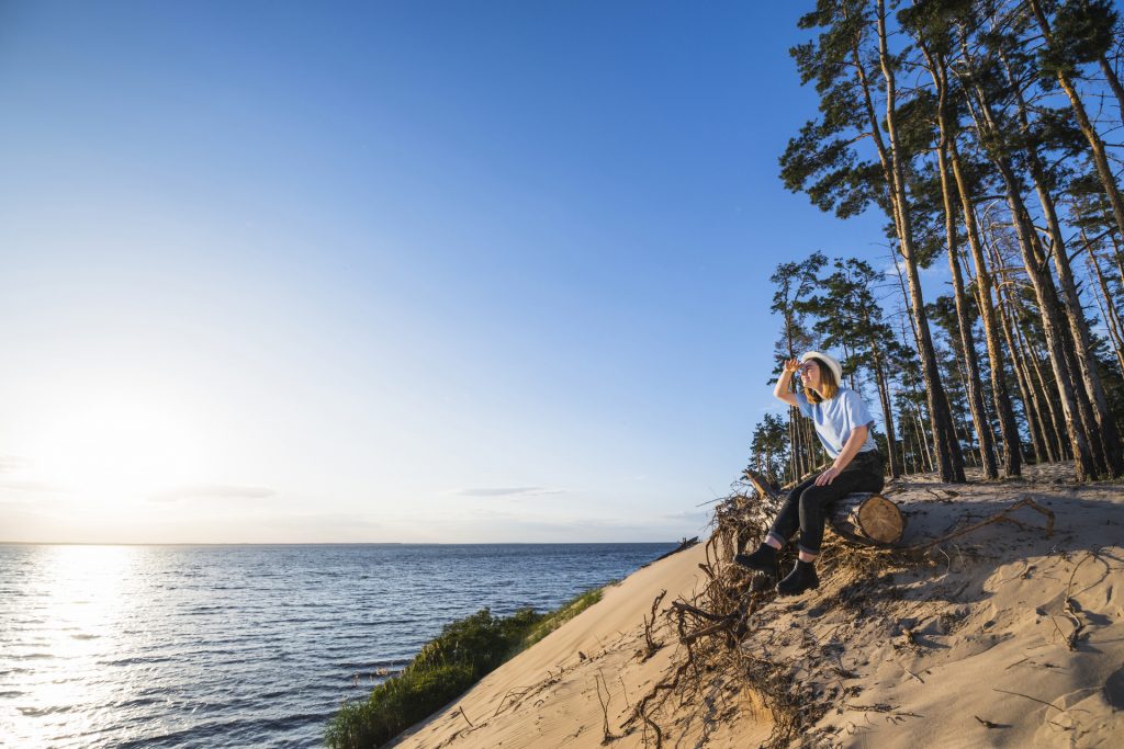 woman-sitting-log-looking-distance (1)